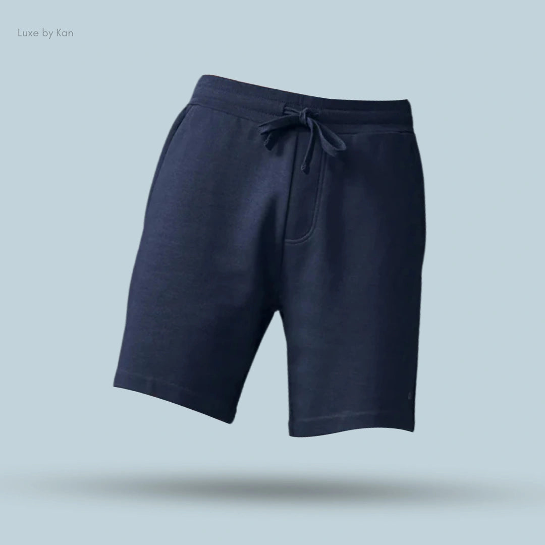 Alo Chill Short in Navy, flat lay on light blue background