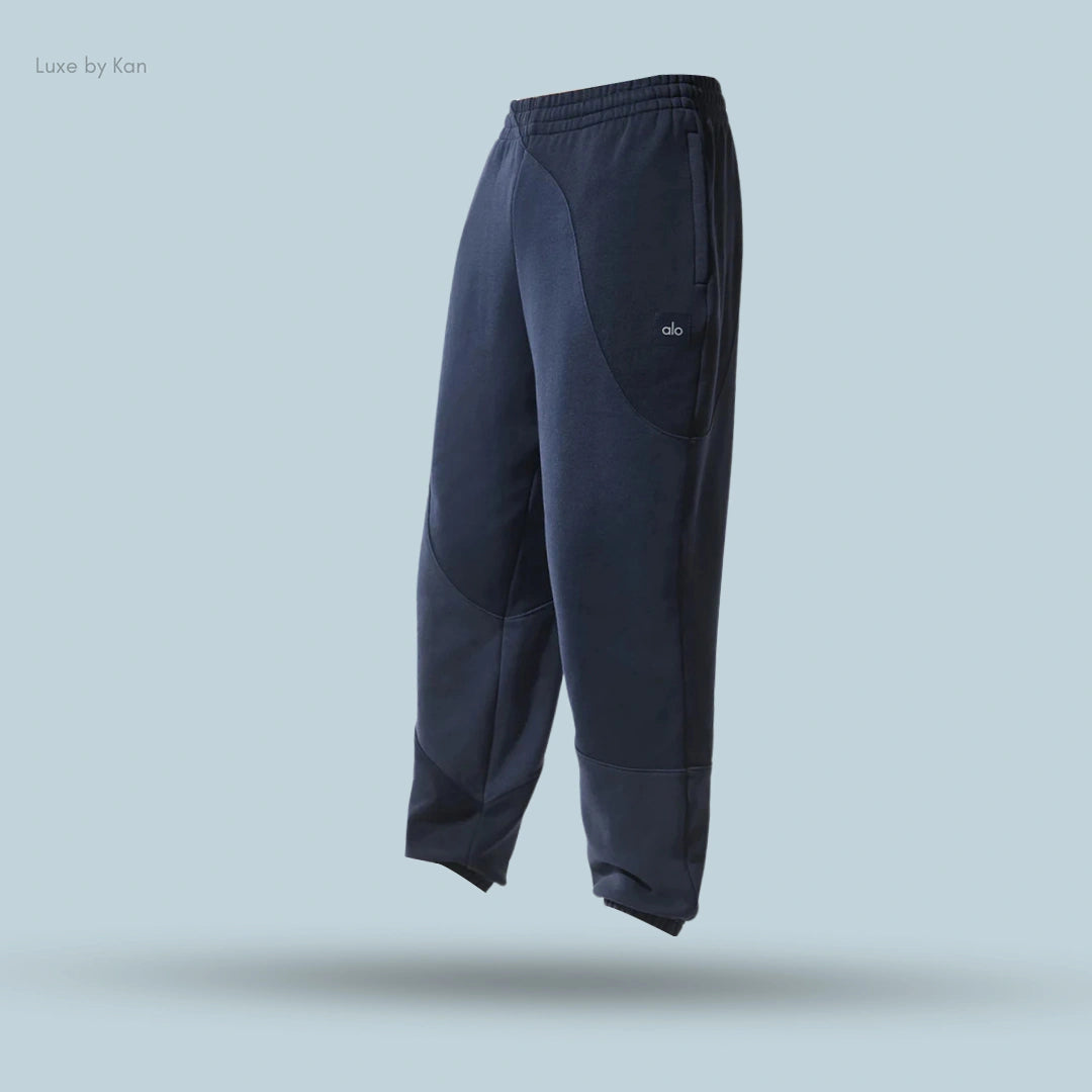 Alo Make Waves Sweatpant in Navy Tonal, flat lay on light blue background