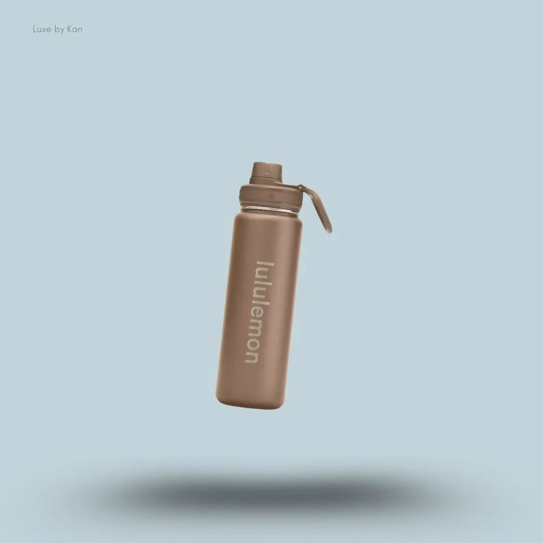 Lululemon Back to Life Sport Bottle 24oz in Nomad, flat lay on light blue background