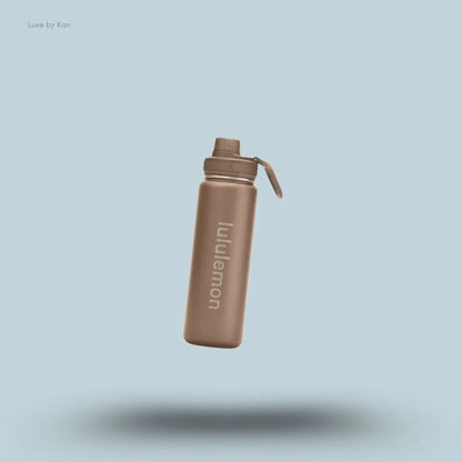Lululemon Back to Life Sport Bottle 24oz in Nomad, flat lay on light blue background