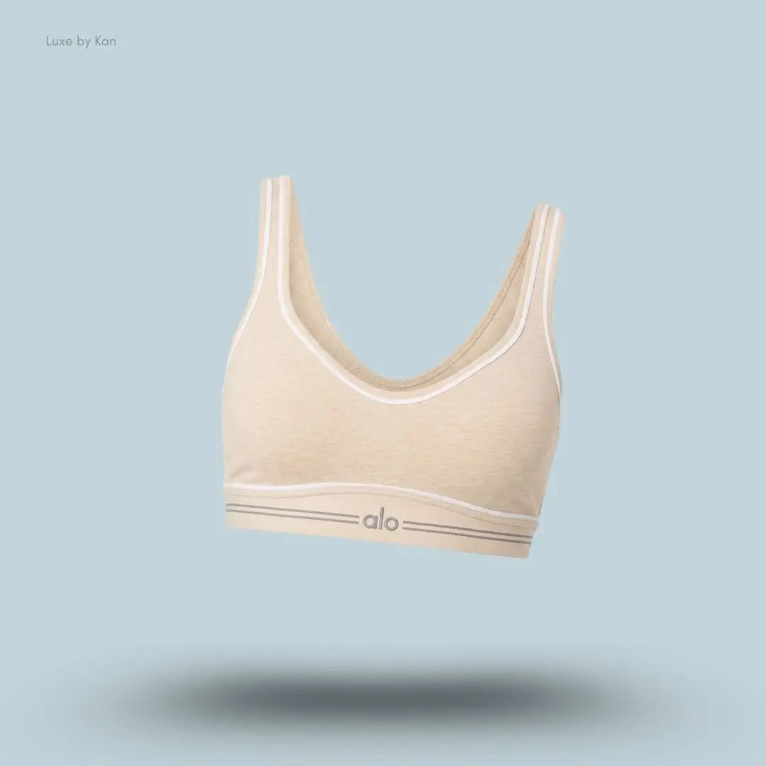 beige Alo Alosoft Heart Throb Bra with thin white trim and Alo logo.