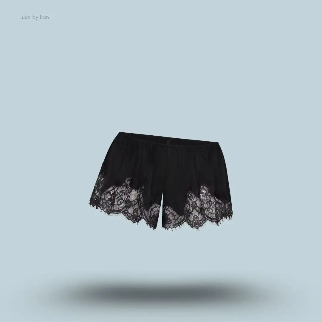 SKIMS Silk Lace Short in Onyx, flat lay on light blue background