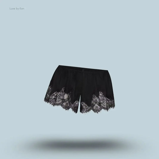 SKIMS Silk Lace Short in Onyx, flat lay on light blue background