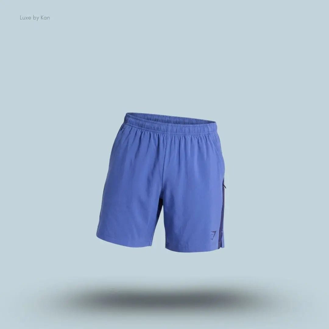Gymshark Sport 7" Shorts in blue with contrast side panels on a blue background