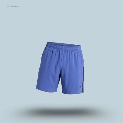 Gymshark Sport 7" Shorts in blue with contrast side panels on a blue background