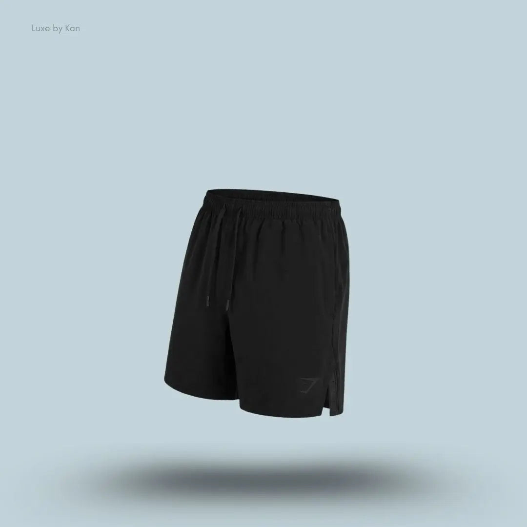 Gymshark Arrival Contrast Shorts in black displayed on a blue background with a slim-fit athletic shorts design
