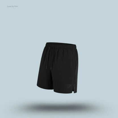 Gymshark Arrival Contrast Shorts in black displayed on a blue background with a slim-fit athletic shorts design
