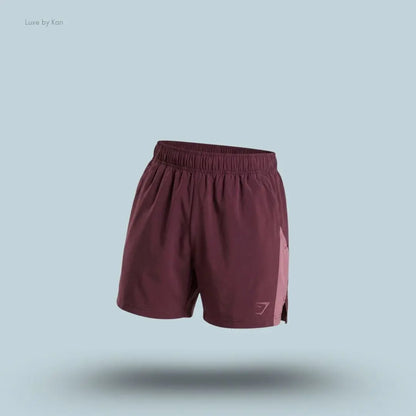 Gymshark Sport 5" Shorts men's slim-fit training shorts in burgundy with contrast side panels on a blue background
