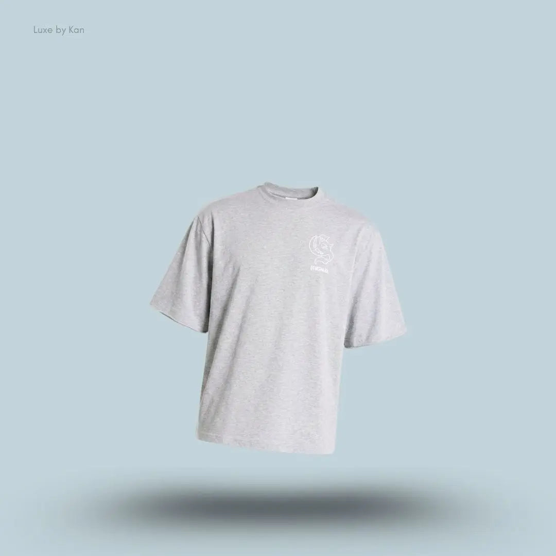 Gymshark Performance T-Shirt in light grey shade displayed on a blue background with an oversized boxy-fit short-sleeve design