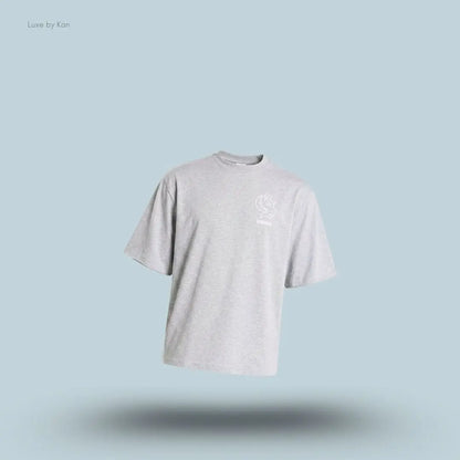 Gymshark Performance T-Shirt in light grey shade displayed on a blue background with an oversized boxy-fit short-sleeve design