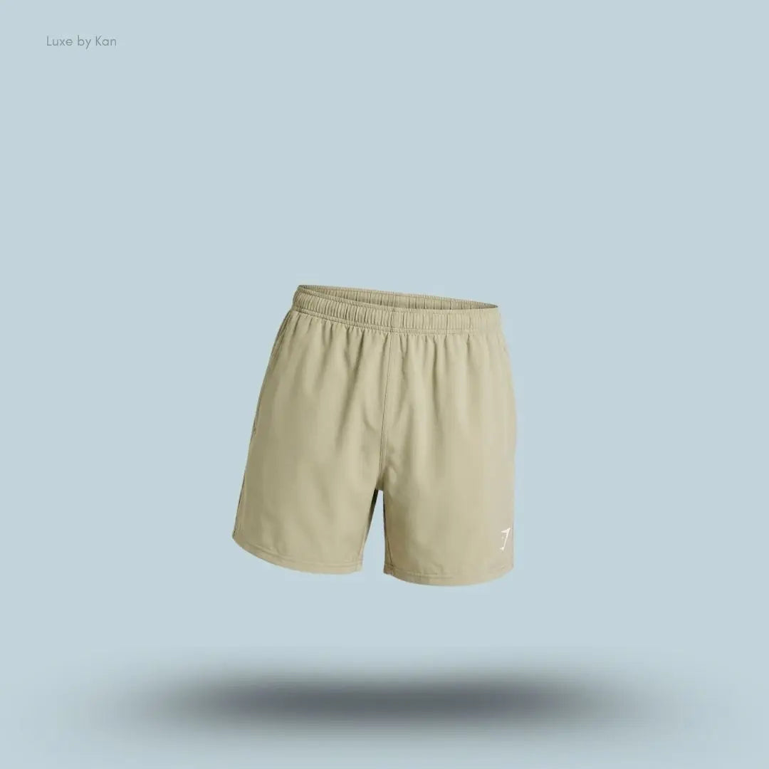 Gymshark Washed Pastels Shorts in pebble grey displayed on a blue background with a relaxed athletic shorts design
