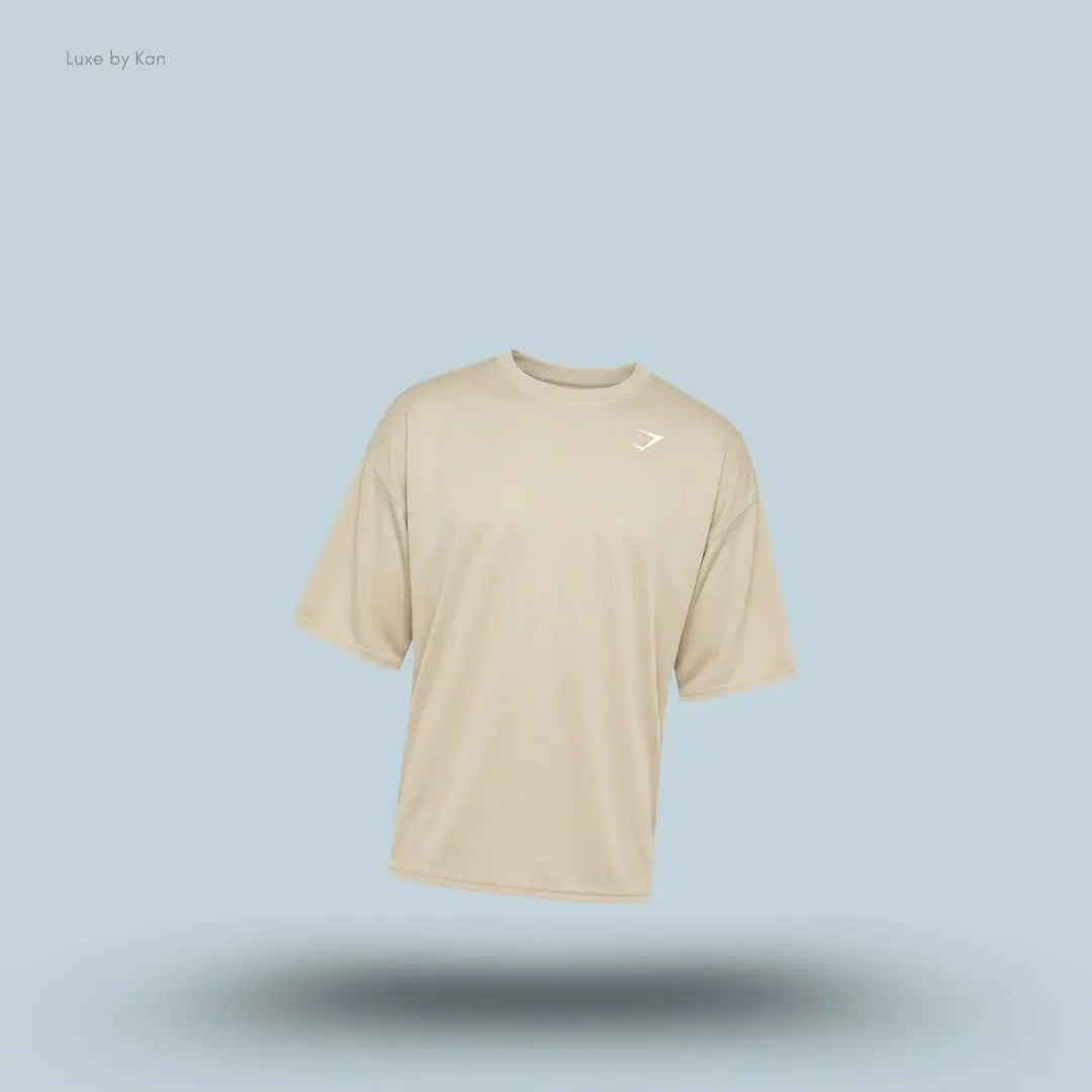 Gymshark Washed Pastels T-Shirt in pebble grey displayed on a blue background with an oversized short-sleeve design