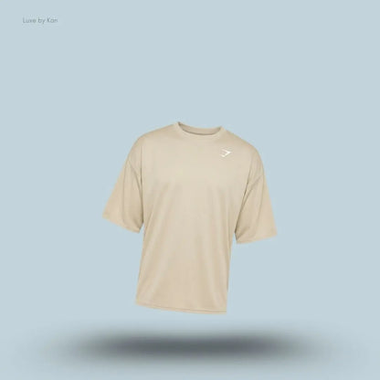 Gymshark Washed Pastels T-Shirt in pebble grey displayed on a blue background with an oversized short-sleeve design