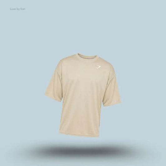Gymshark Washed Pastels T-Shirt in pebble grey displayed on a blue background with an oversized short-sleeve design