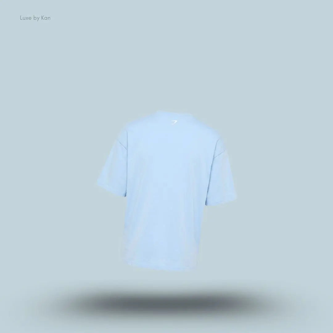 Gymshark Athletic Division Graphic T-Shirt in light blue back view with front graphic print on a blue background