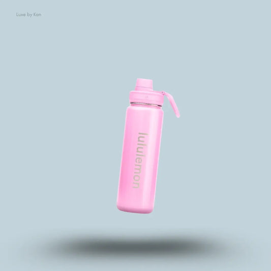 Lululemon Back to Life Sport Bottle 24oz Shine in Pink Pearl, on light blue background