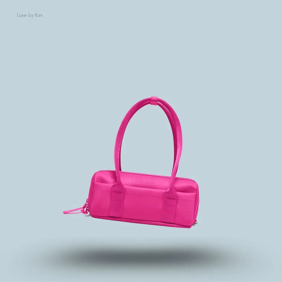 Gymshark Everyday Baguette Bag in  pink displayed on a blue background with a classic short-handle design