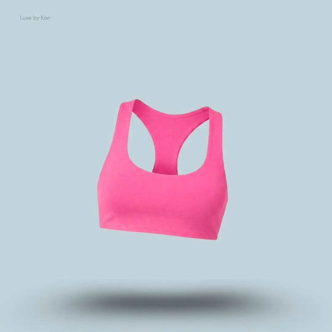 Alo Airlift Advantage Racerback Bra in pink, flat lay on light blue background