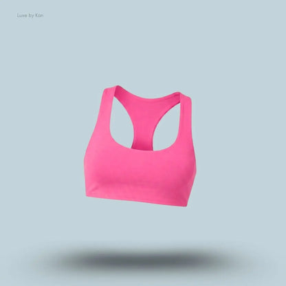 Alo Airlift Advantage Racerback Bra in pink, flat lay on light blue background