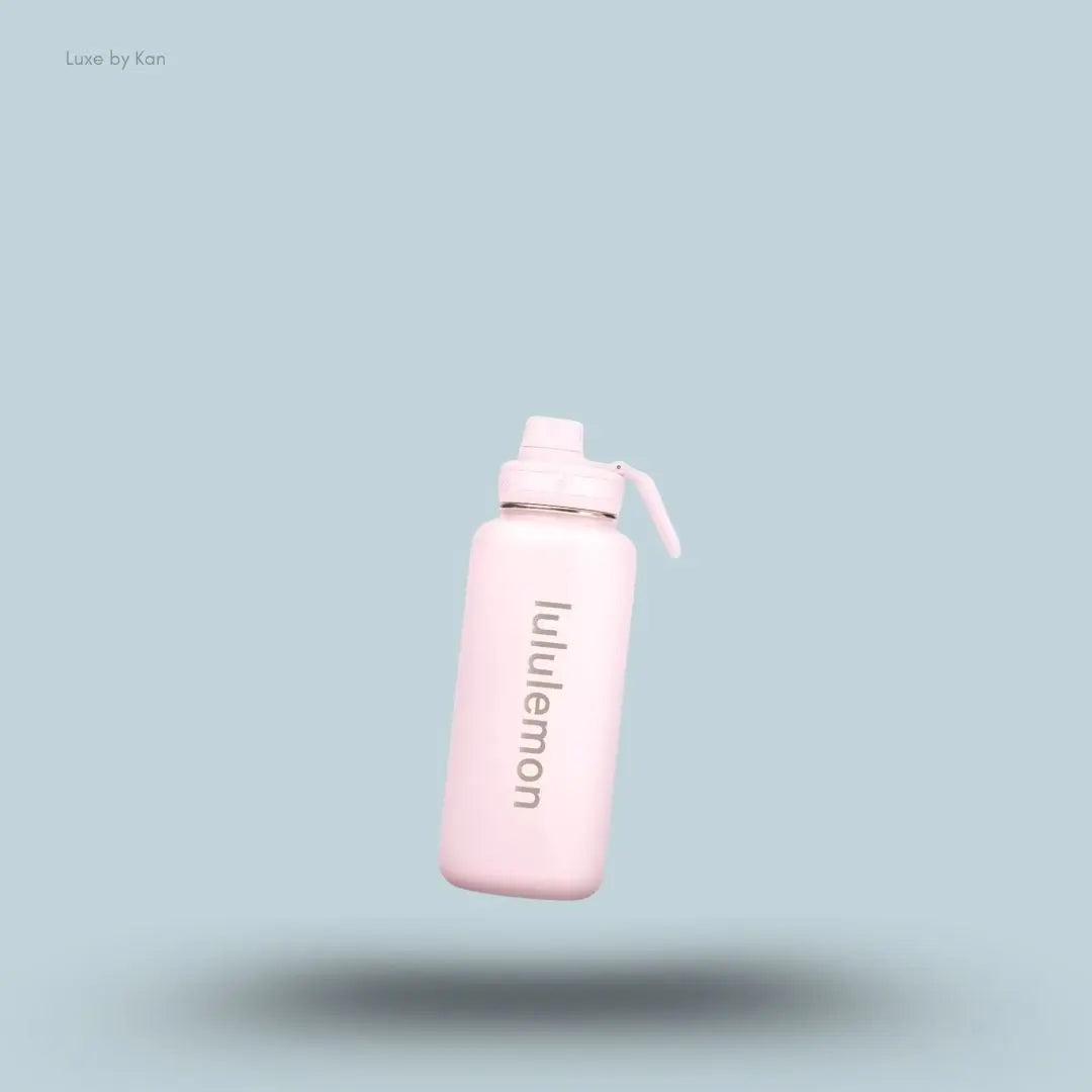 Lululemon Back to Life Sport Bottle 32oz in Pink Pearl, flat lay on light blue background