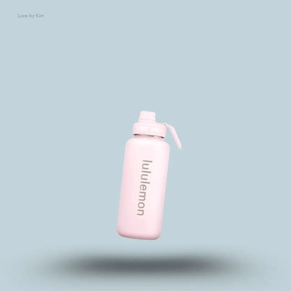 Lululemon Back to Life Sport Bottle 32oz in Pink Pearl, flat lay on light blue background