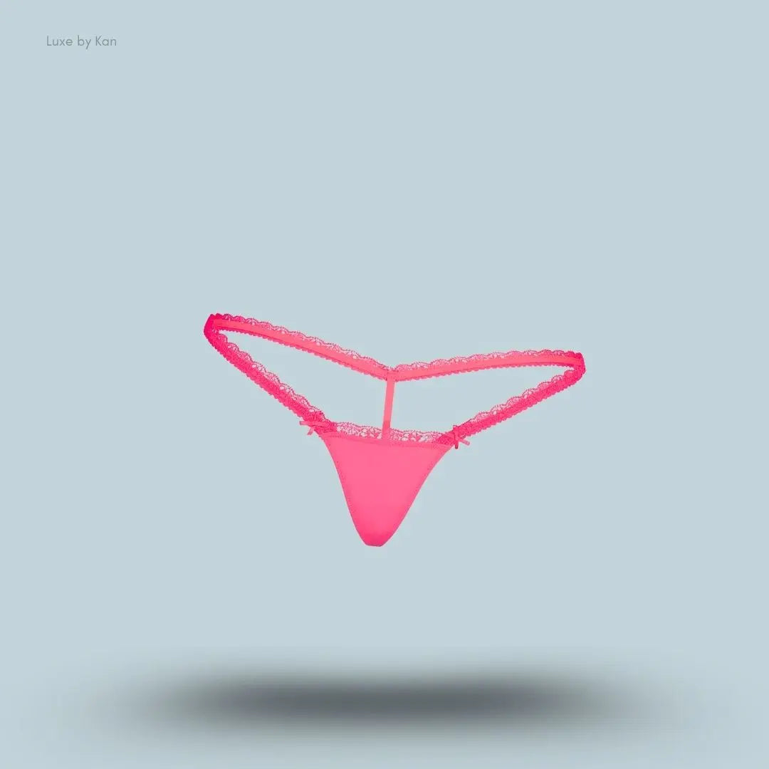 SKIMS Fits Everybody Lace Micro Thong in Ultra Pink, flat lay on light blue background