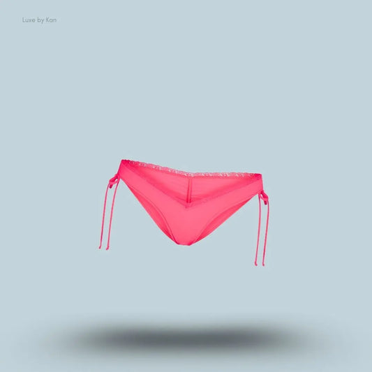 SKIMS Fits Everybody Lace Micro Tanga in Ultra Pink, flat lay on light blue background