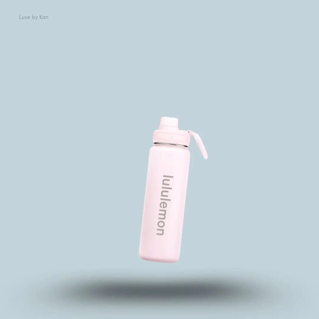 Lululemon Back to Life Sport Bottle 24oz in Pink Pearl, flat lay on light blue background