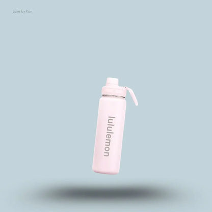Lululemon Back to Life Sport Bottle 24oz in Pink Pearl, flat lay on light blue background