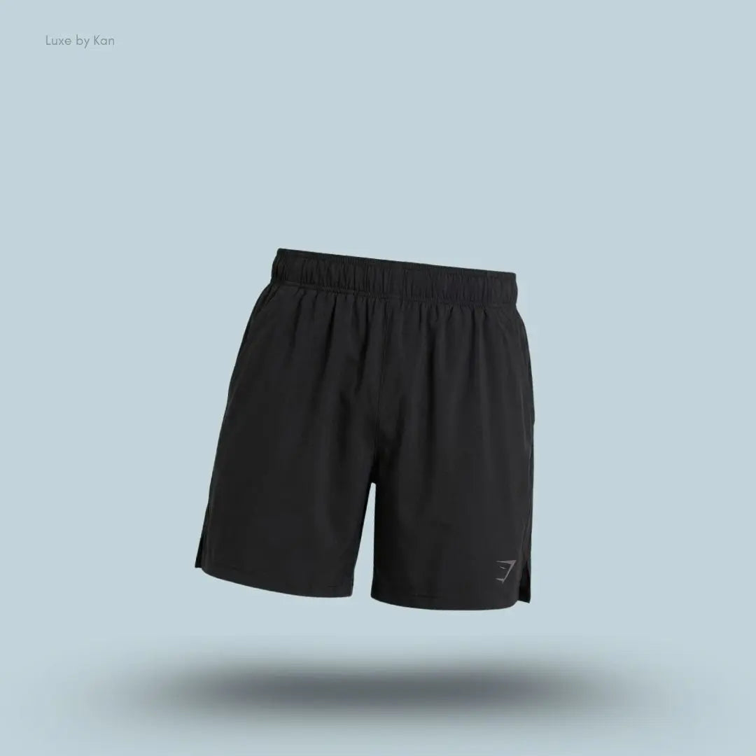 Gymshark Sport 7" Shorts in black with side panels on a blue background