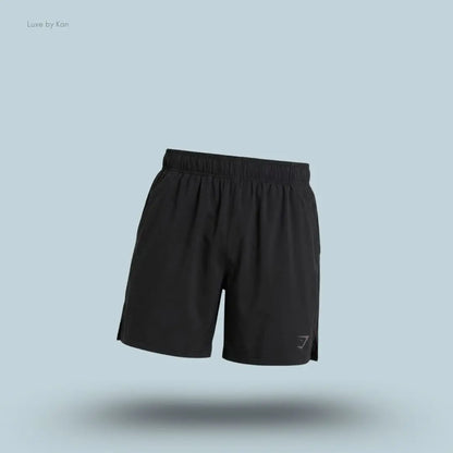 Gymshark Sport 7" Shorts in black with side panels on a blue background