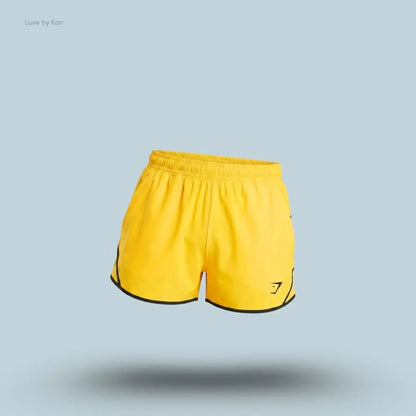 gymshark Accent Conditioning Shorts in yellow with black trim, lightweight men's training shorts with logo detail