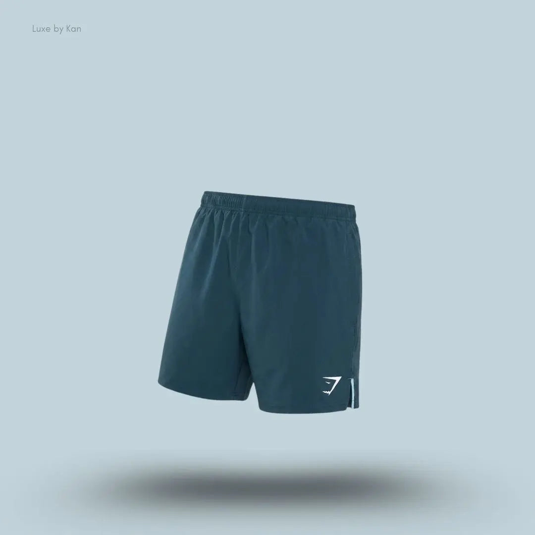 Gymshark Arrival Contrast Shorts in stealth blue displayed on a blue background with a slim-fit athletic shorts design