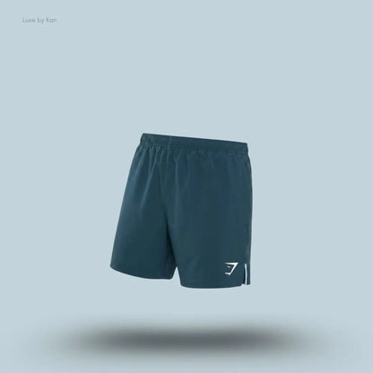 Gymshark Arrival Contrast Shorts in stealth blue displayed on a blue background with a slim-fit athletic shorts design