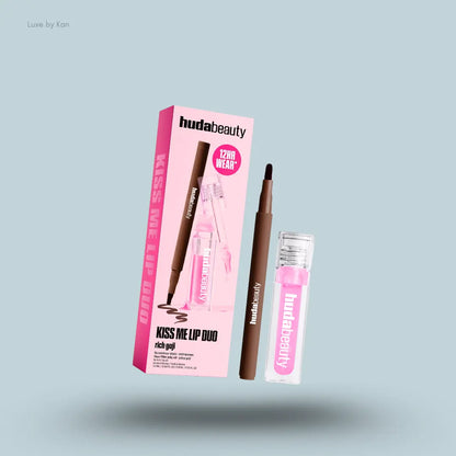 Huda Beauty Kiss Me Lip Duo two lip products with packaging on blue background