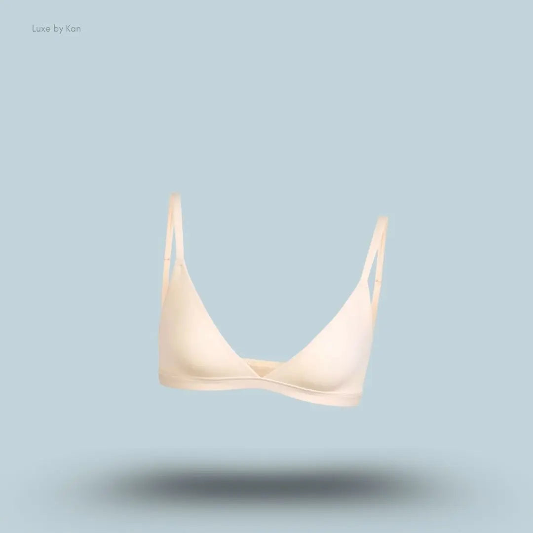 Skims Fits Everybody Triangle Bralette in beige, front view on a light blue background with a floating product display.