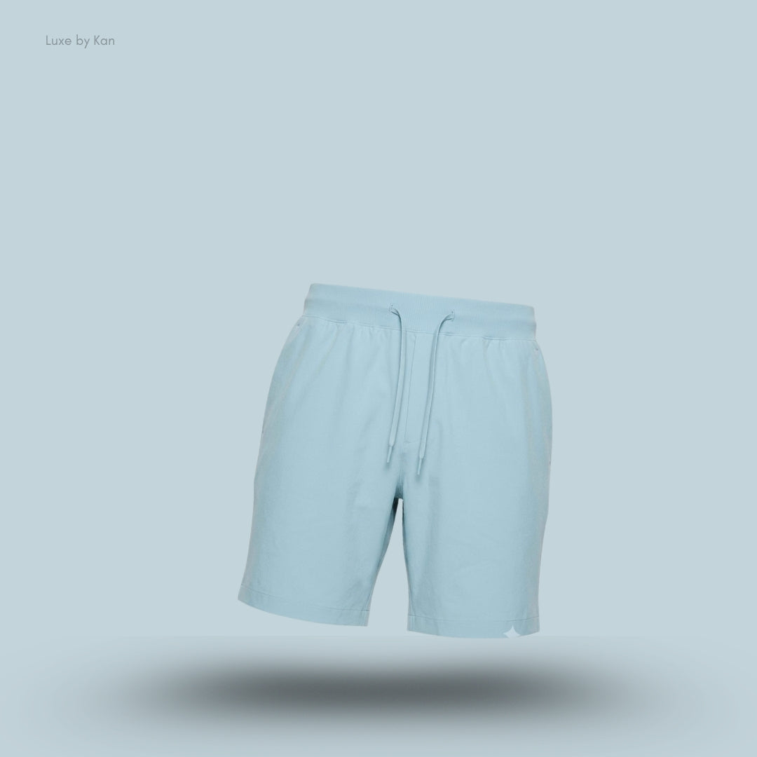 Lululemon Zeroed In Linerless Short 7 inch in seaform, flat lay on light blue background