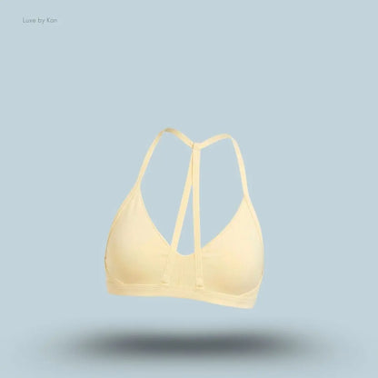 Gymshark Minimal Sports Bra 2.0 in Butter Yellow back view, flat lay on light blue background