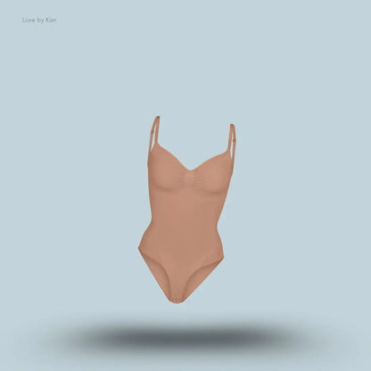 SKIMS Seamless Sculpt Brief Bodysuit in a light brown shade, front view with adjustable shoulder straps and seamless sculpting design on blue background