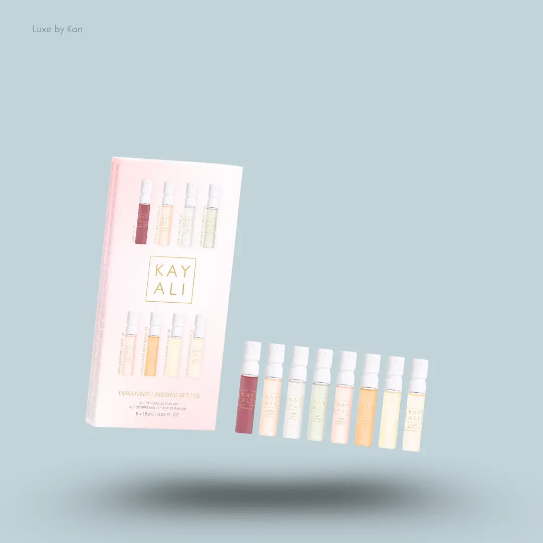 Kayali Discovery Layering Set eight perfume bottles with packaging on blue background