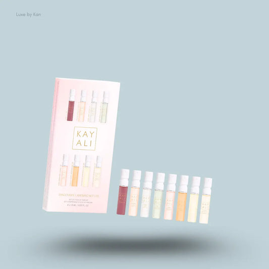 Kayali Discovery Layering Set eight perfume bottles with packaging on blue background