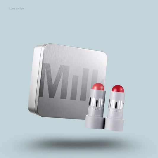 Milk Makeup Lip + Cheek Duo – two sticks with packaging on blue background