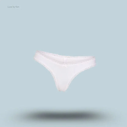 SKIMS Lightweight Cotton Lace Thong in Snow, flat lay on light blue background