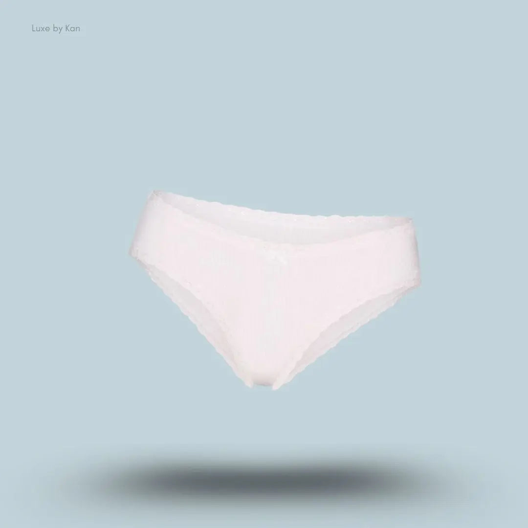 SKIMS Lightweight Cotton Pointelle Lace Brief in Snow, flat lay on light blue background