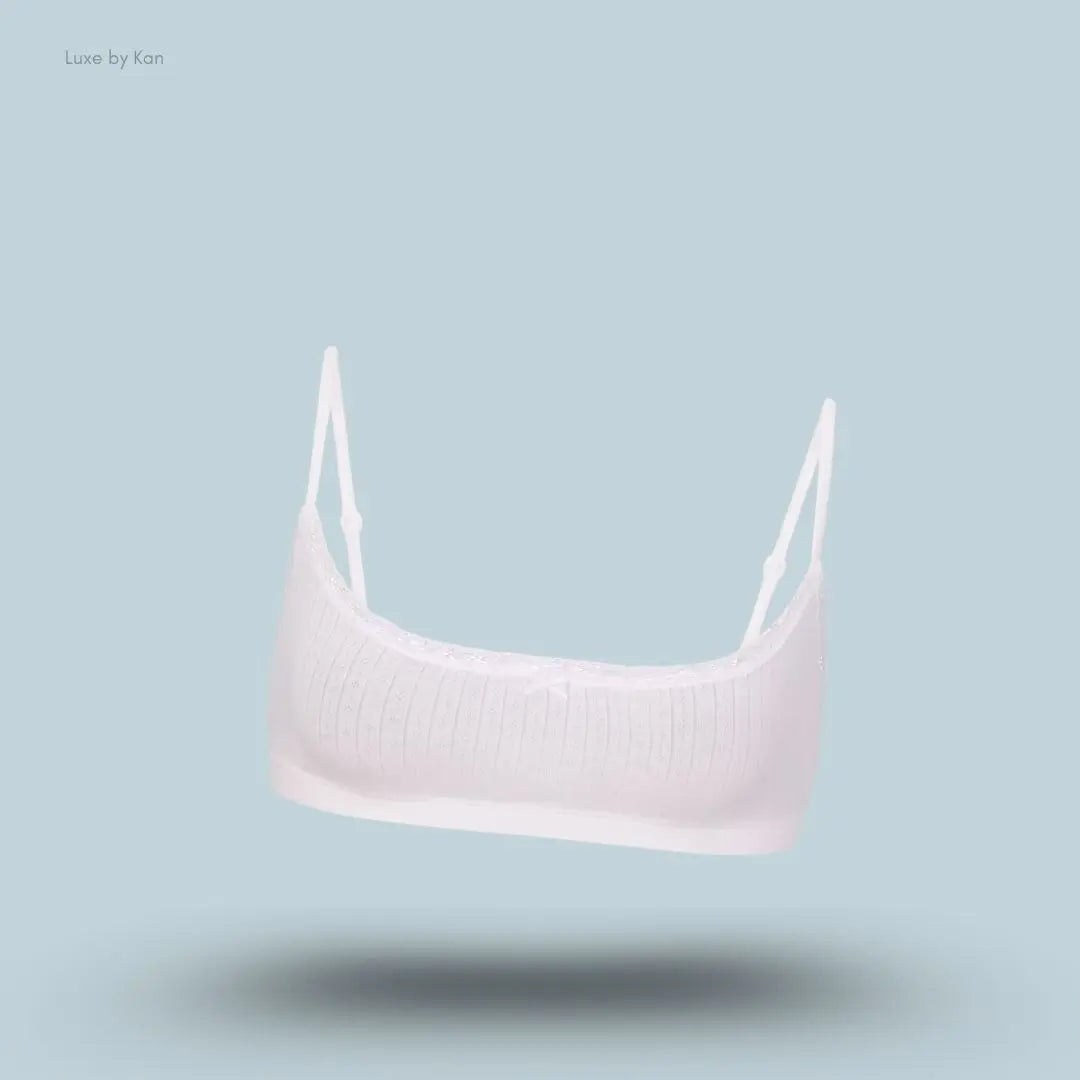 SKIMS Lightweight Cotton Pointelle Scoop Bralette in Snow, flat lay on light blue background