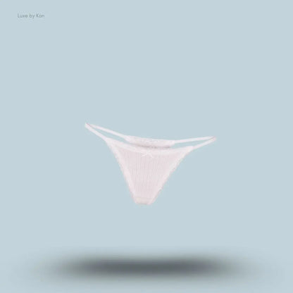 SKIMS Lightweight Cotton Pointelle Lace String Thong in Snow, flat lay on light blue background
