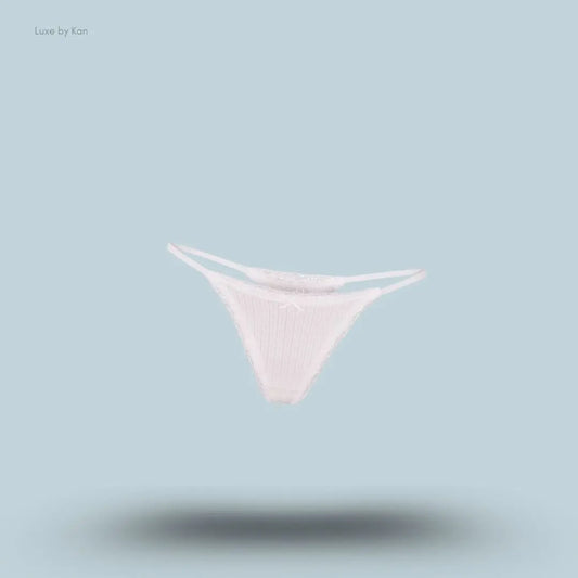 SKIMS Lightweight Cotton Pointelle Lace String Thong in Snow, flat lay on light blue background