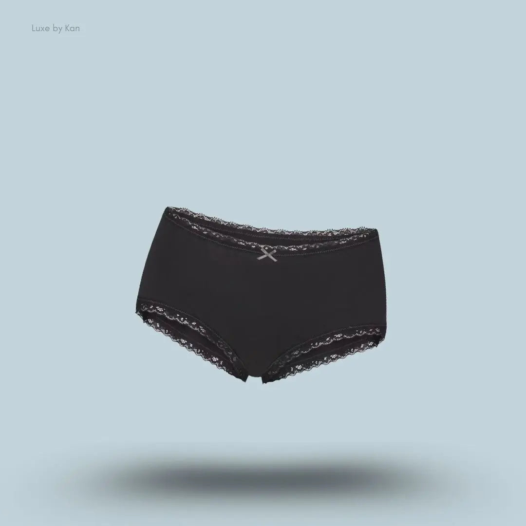 SKIMS Lightweight Cotton Lace Boy Short in Soot, flat lay on light blue background