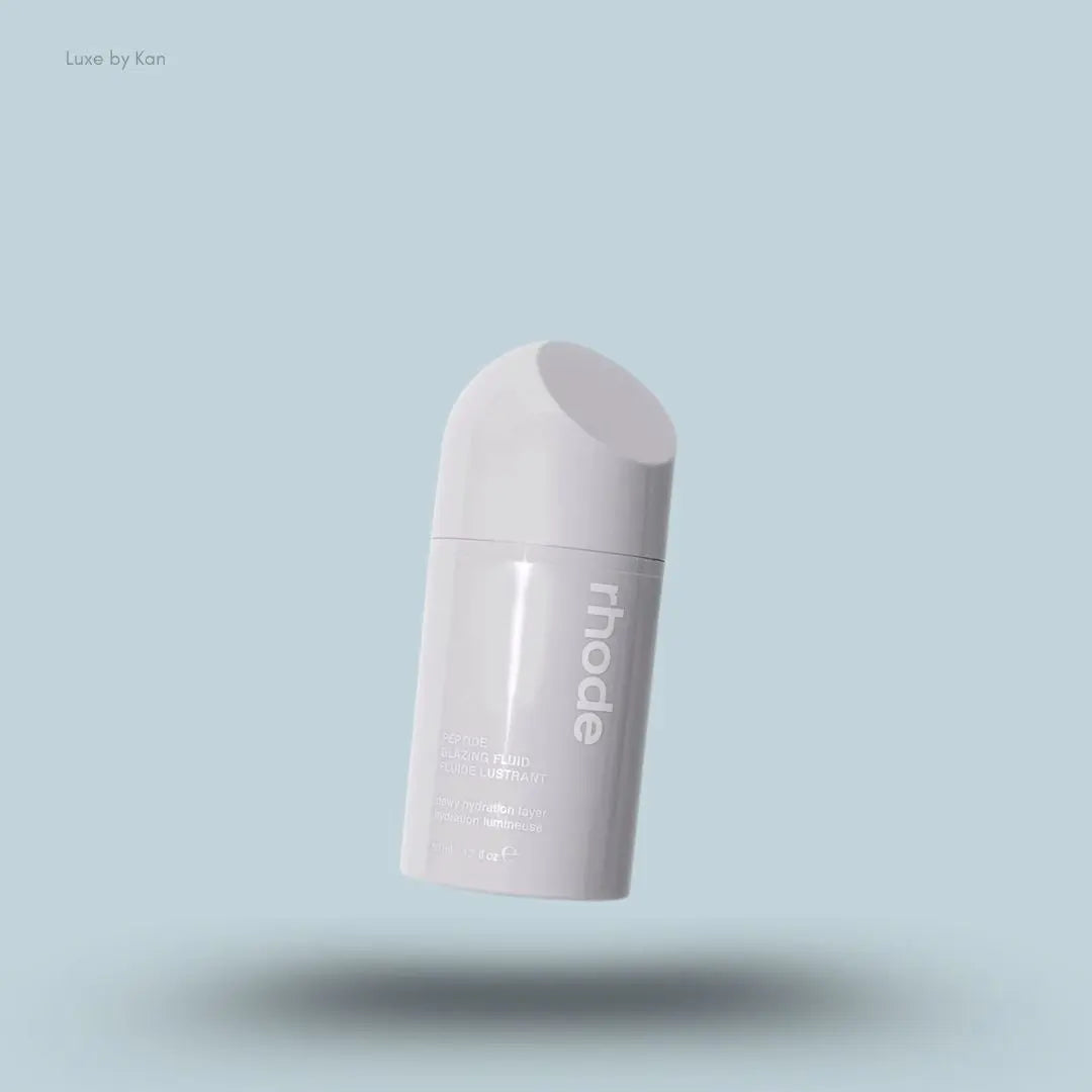 Rhode Peptide Glazing Fluid in an opaque gray container with the brand name in white on the side.