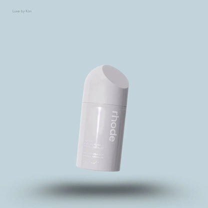 Rhode Peptide Glazing Fluid in an opaque gray container with the brand name in white on the side.